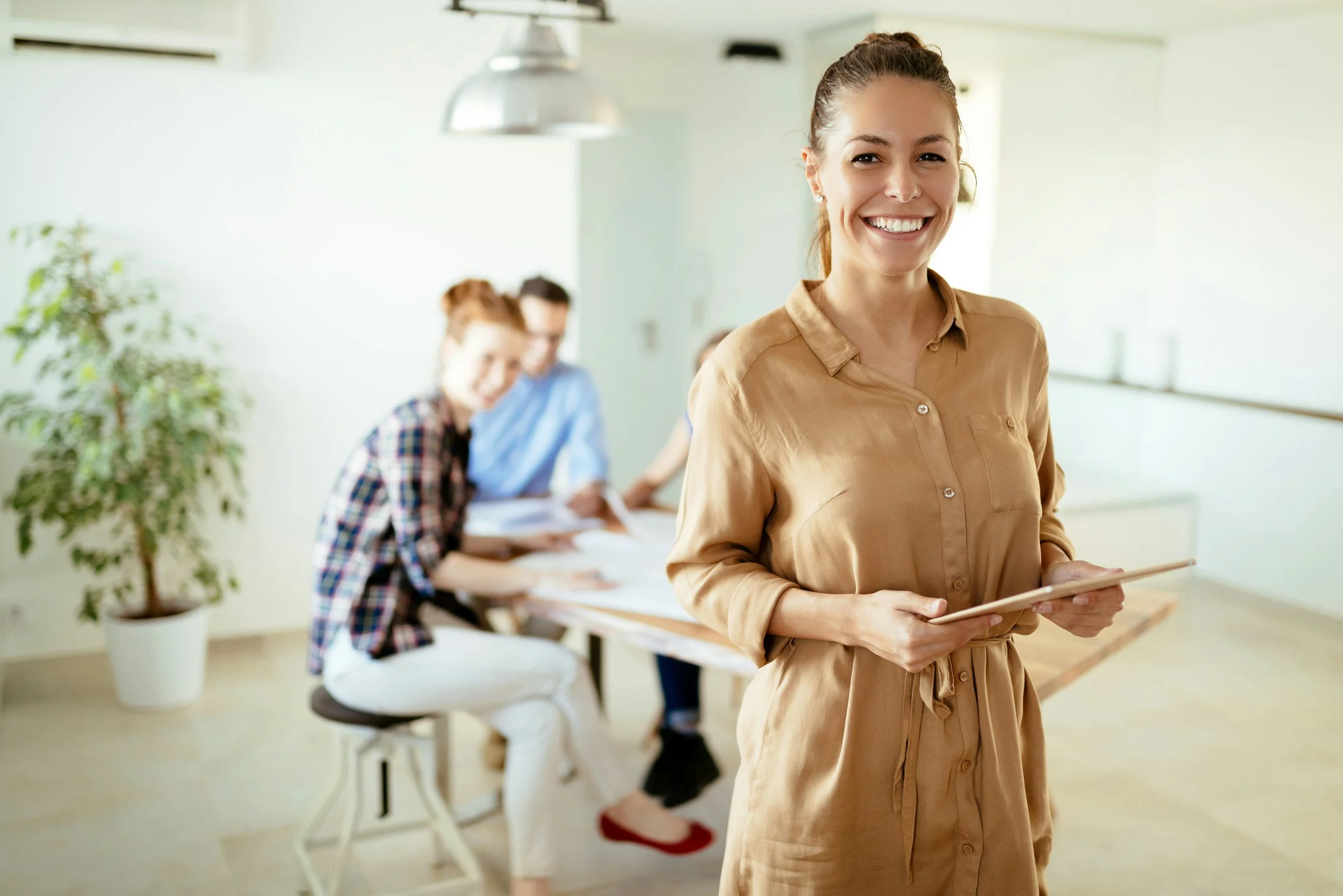 A confident team leader in a healthy workplace, reflecting the manager's central role in employee wellbeing.