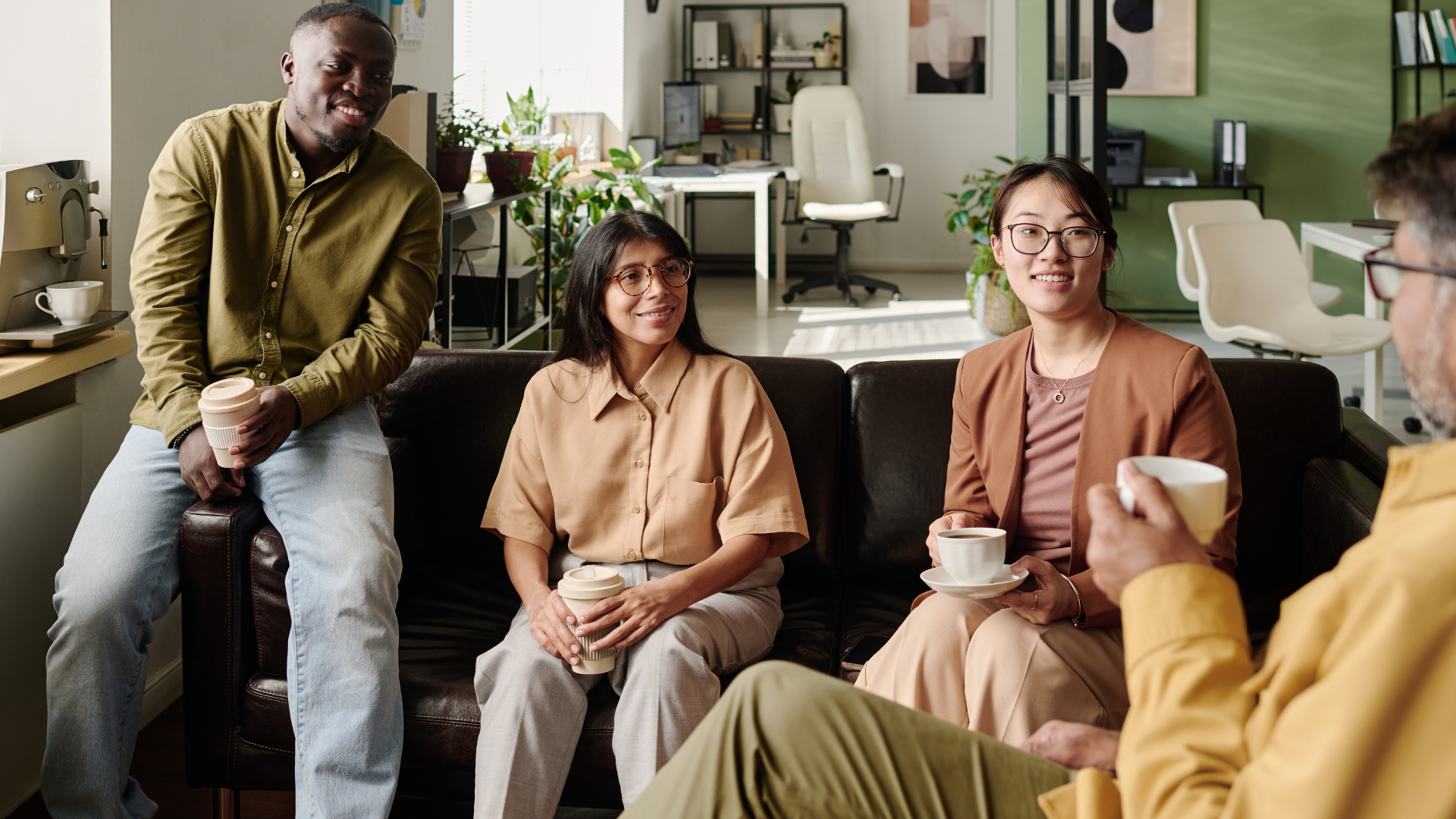 Diverse employees speaking together in a safe, trauma-informed workplace