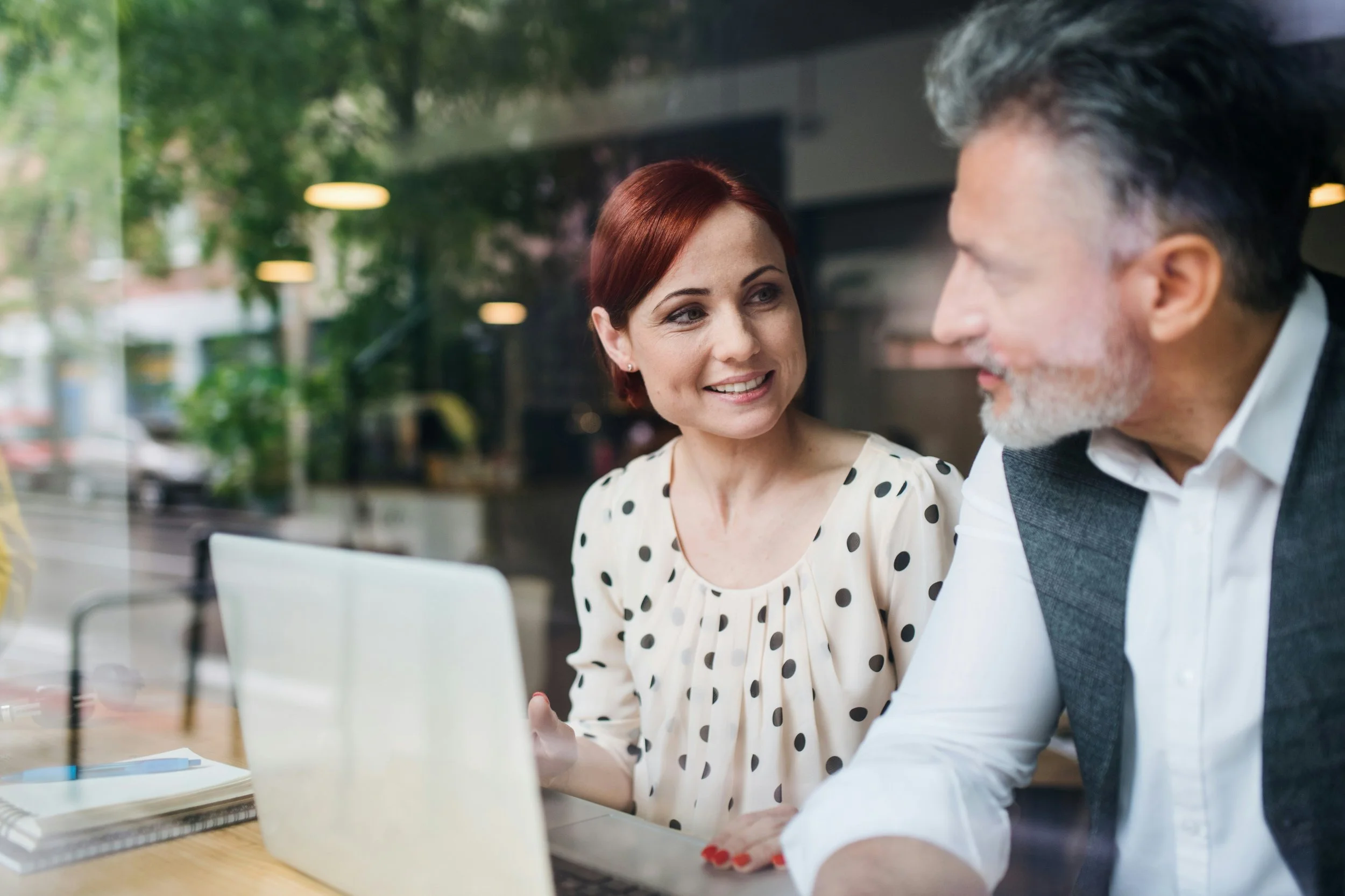 Younger woman mentoring an older male colleague