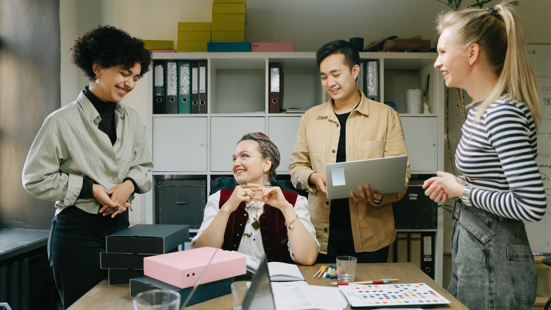 Healthy team gathered in an office collaborating effectively using key leadership skills