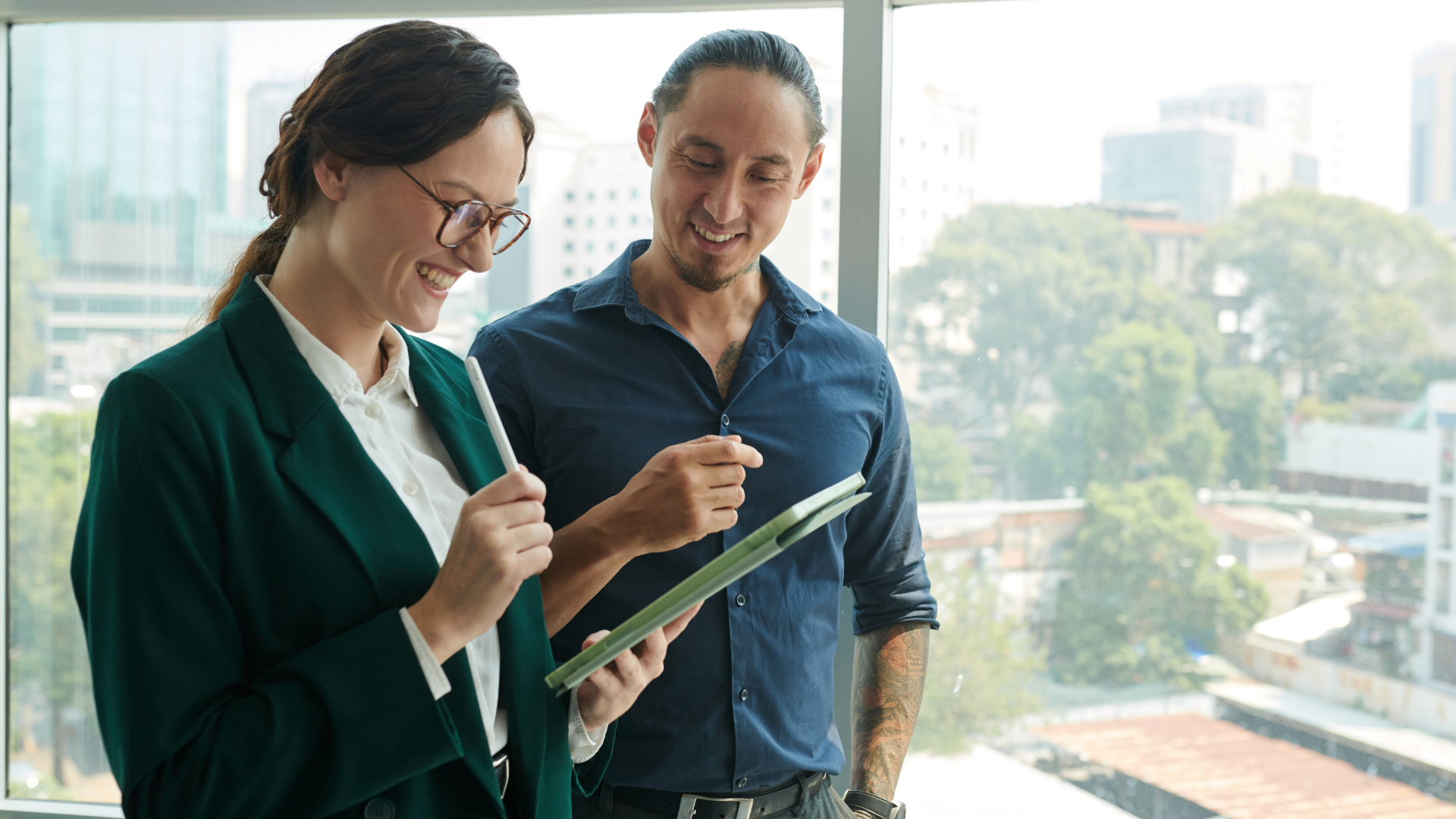 Two office professionals discussing a project, representing the scaffolded support and clear communication that drives successful delegation