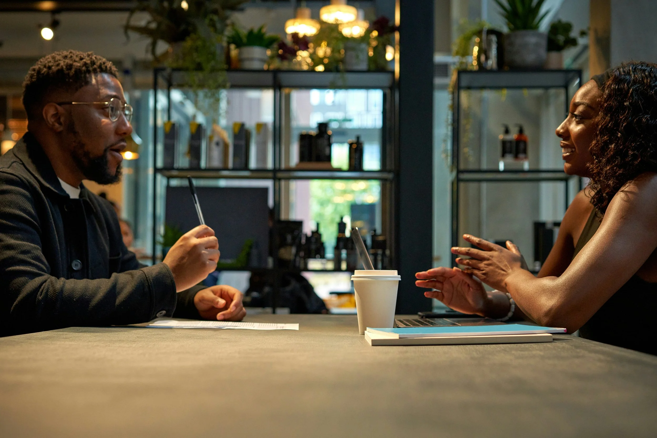 A professional making their case in a one-on-one, the kind of clear, direct communication that managing up depends on.