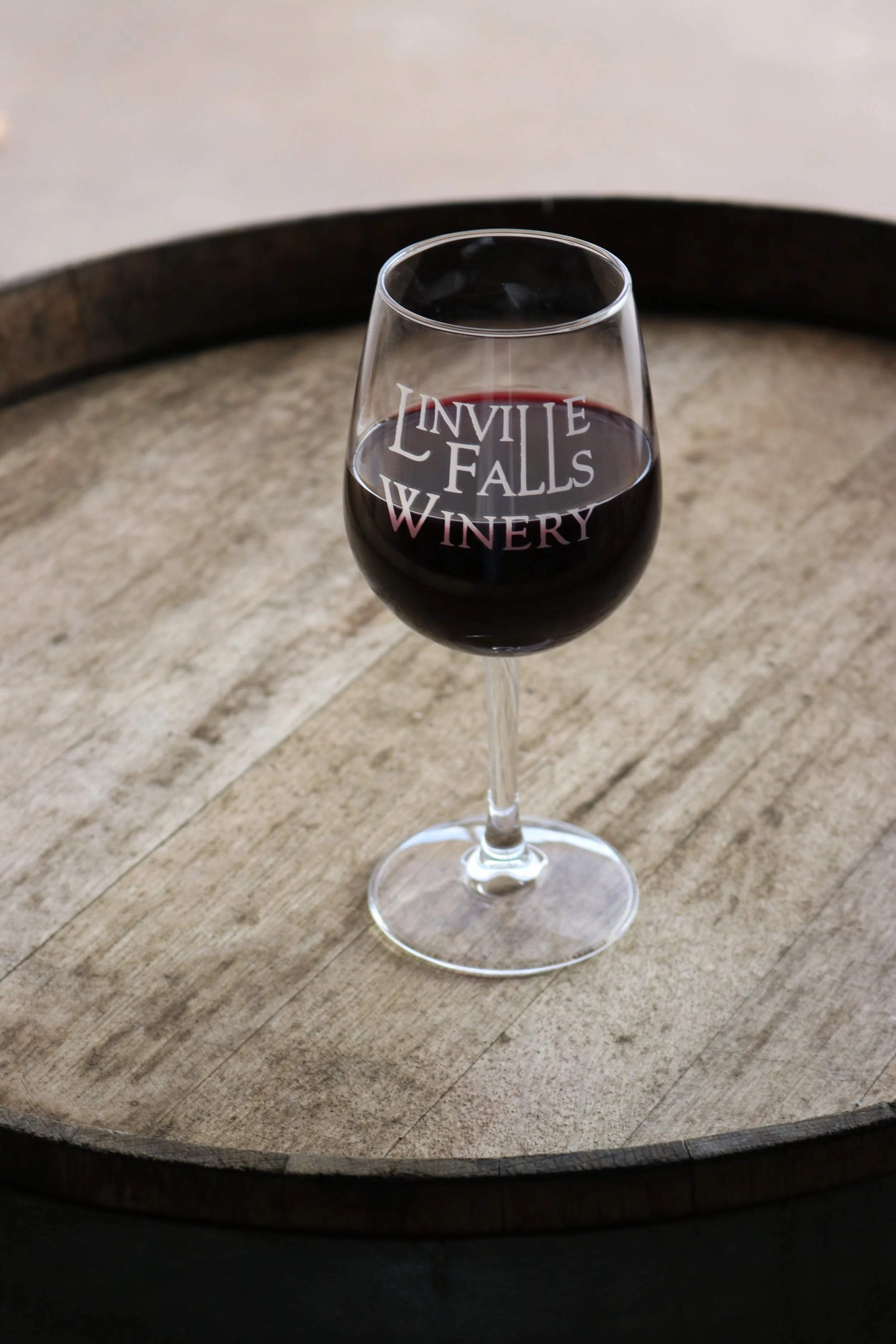 glass of red wine on barrel.JPG