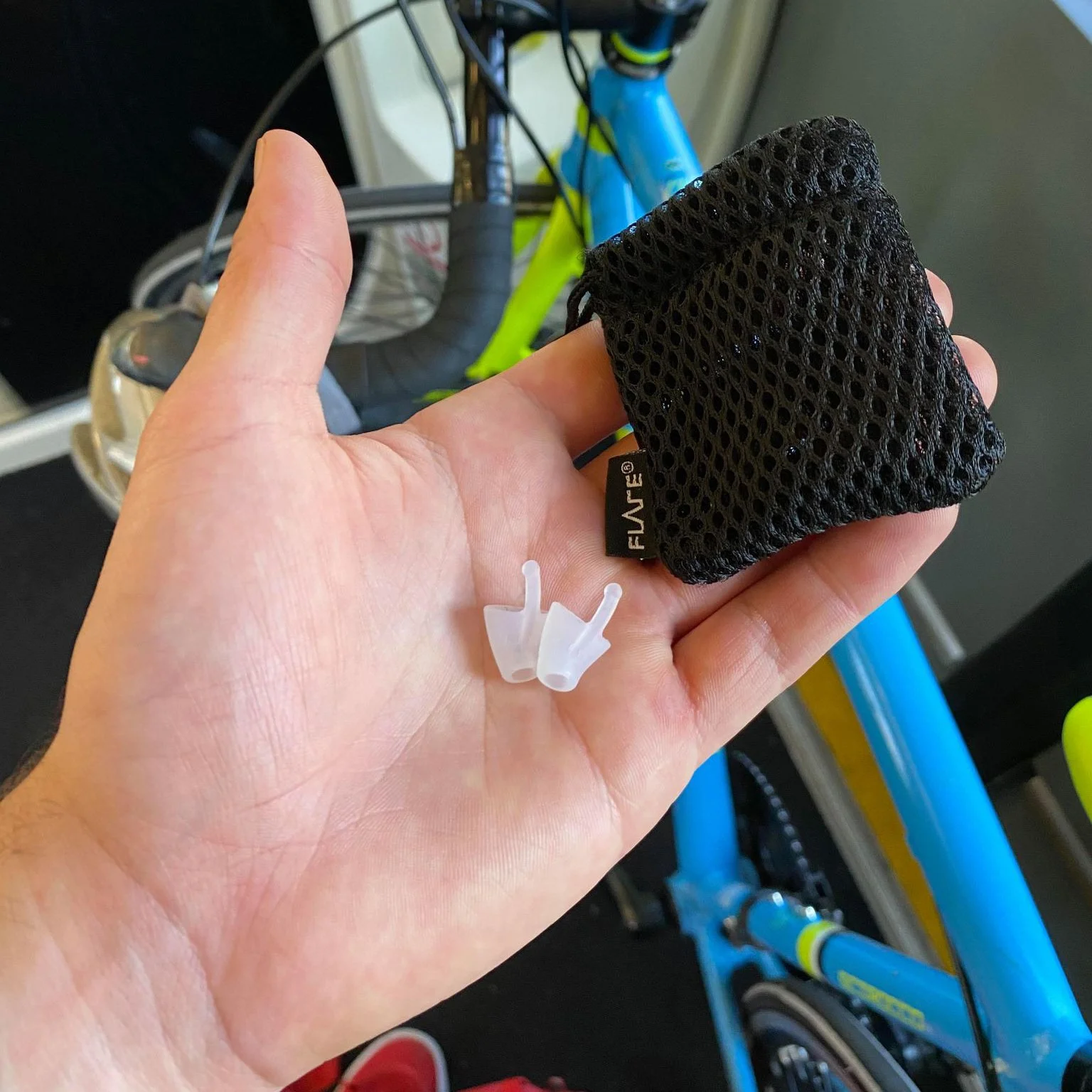 Person with Flare Calmer Earbuds in palm of hand