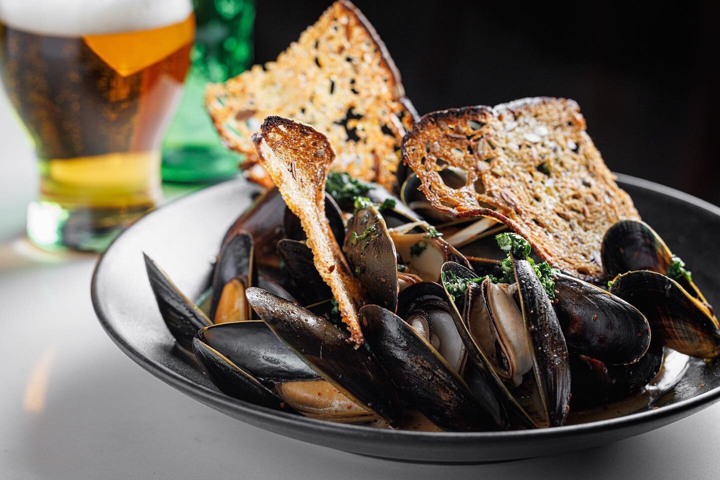 How about mussels to start the weekend 😍 ⁠
⁠
@letourevanston Brothy Banger Mussels - spicy, red harissa broth with white wine-butter.