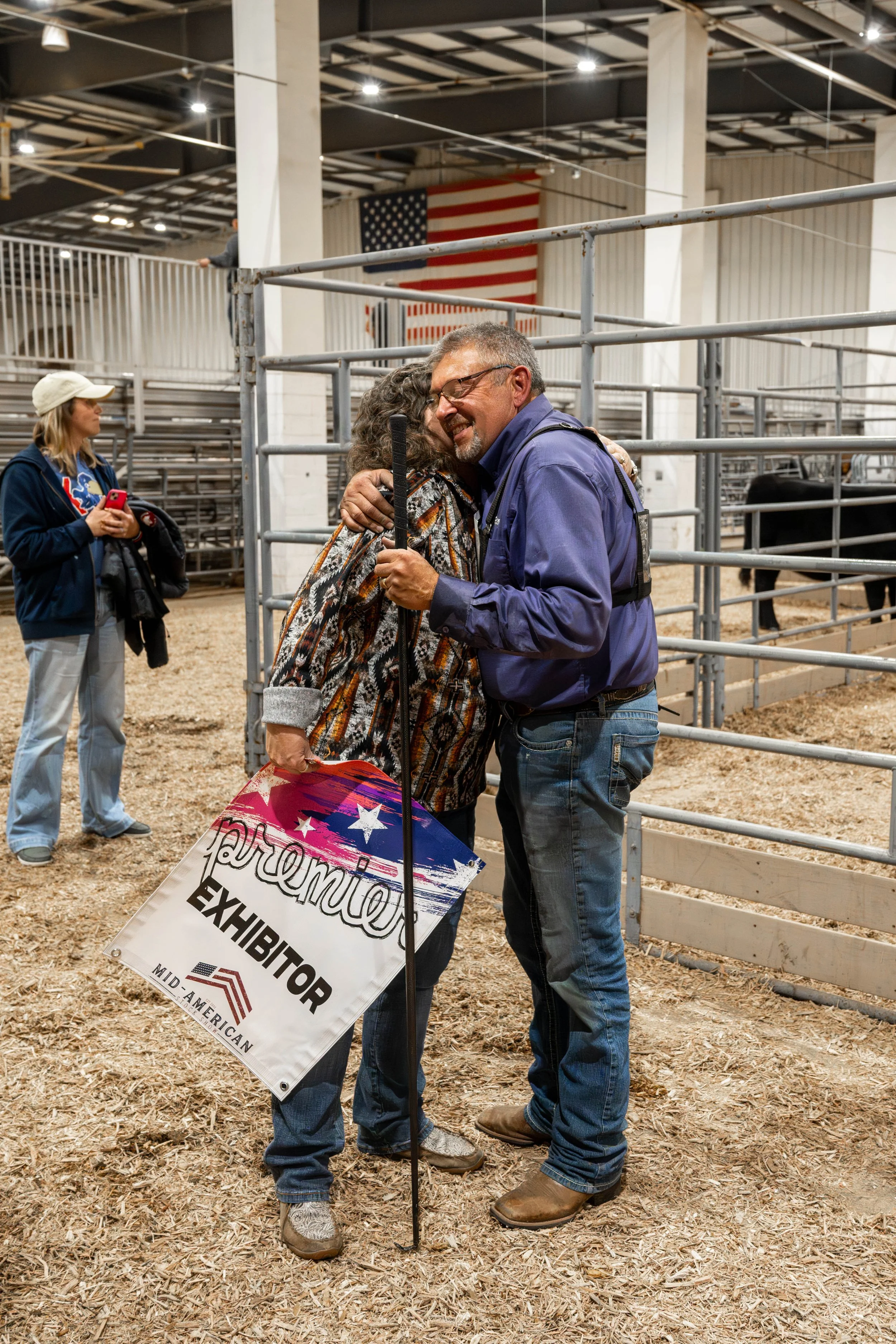 Two adults hugging after winning premier exhibitor at the Mid-American Stock Show