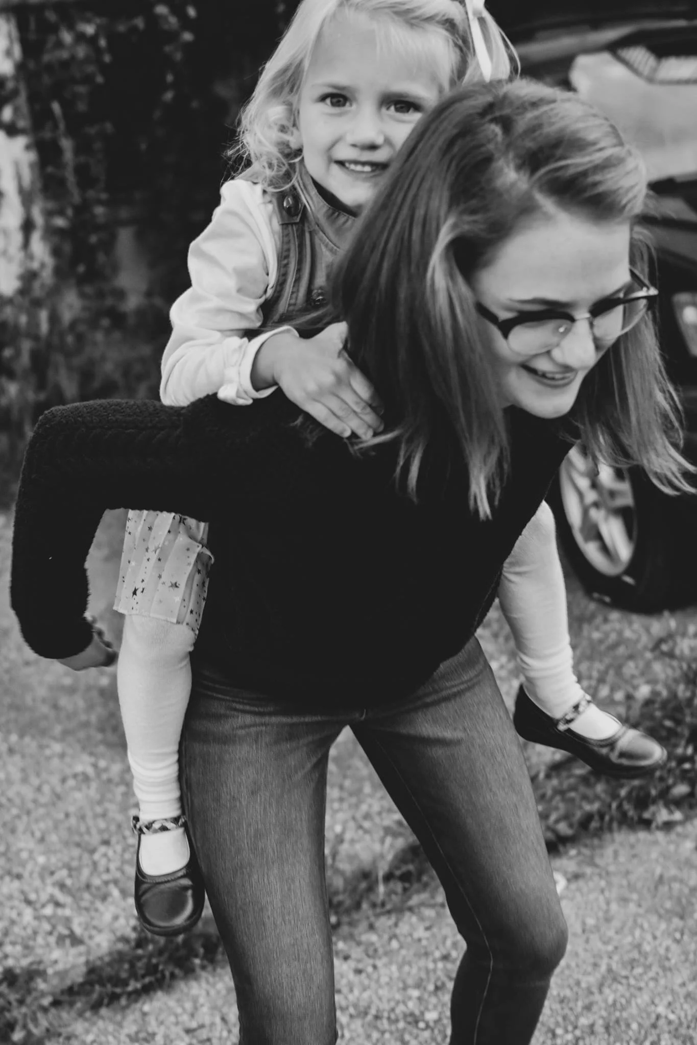 Woman giving a piggyback ride to a young girl
