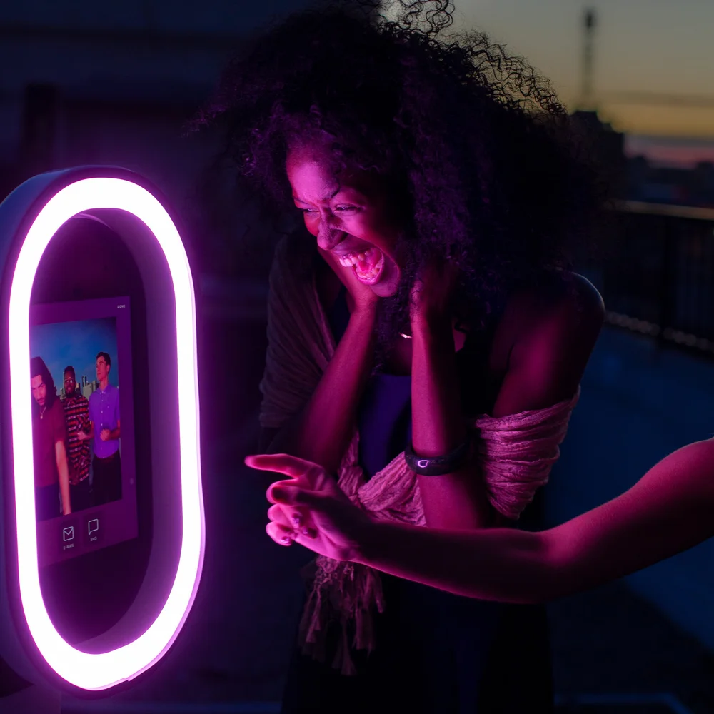 Guest laughing at digital photo booth in Miami
