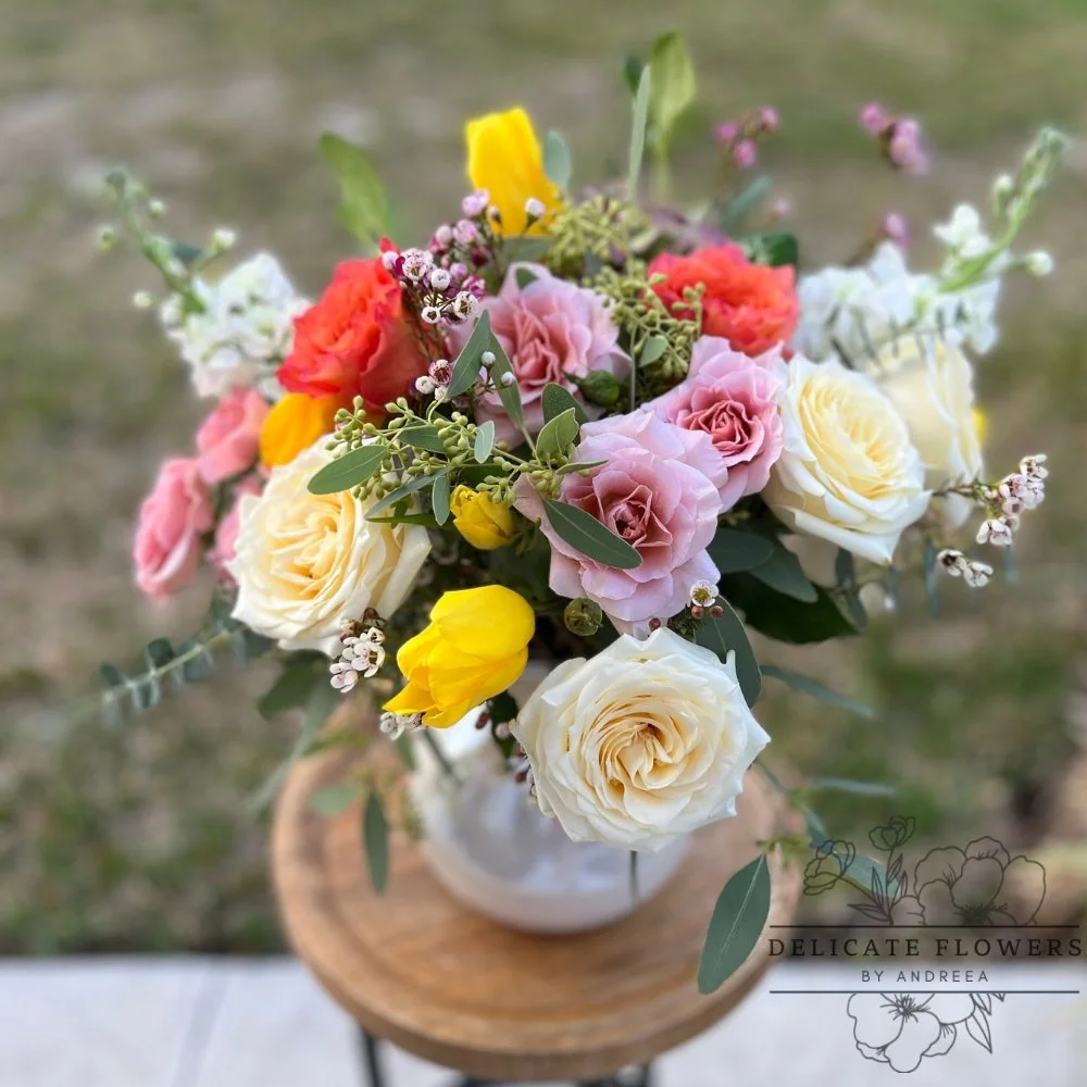 Springtime Elegance bouquet with pastel roses, yellow tulips, and lush greenery