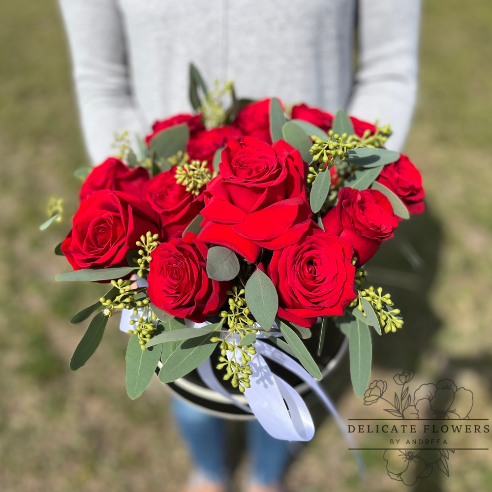 Dozen Roses features twelve rich red roses accented with fresh greenery and finished with a classic ribbon. A timeless and elegant bouquet symbolizing love, passion, and devotion. Handcrafted flower delivery in Wesley Chapel, FL