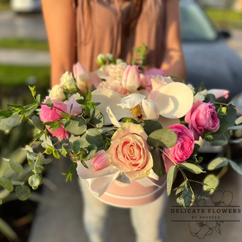 Magnolia Love flower arrangement with white magnolias, blush and pink roses, ranunculus, and eucalyptus