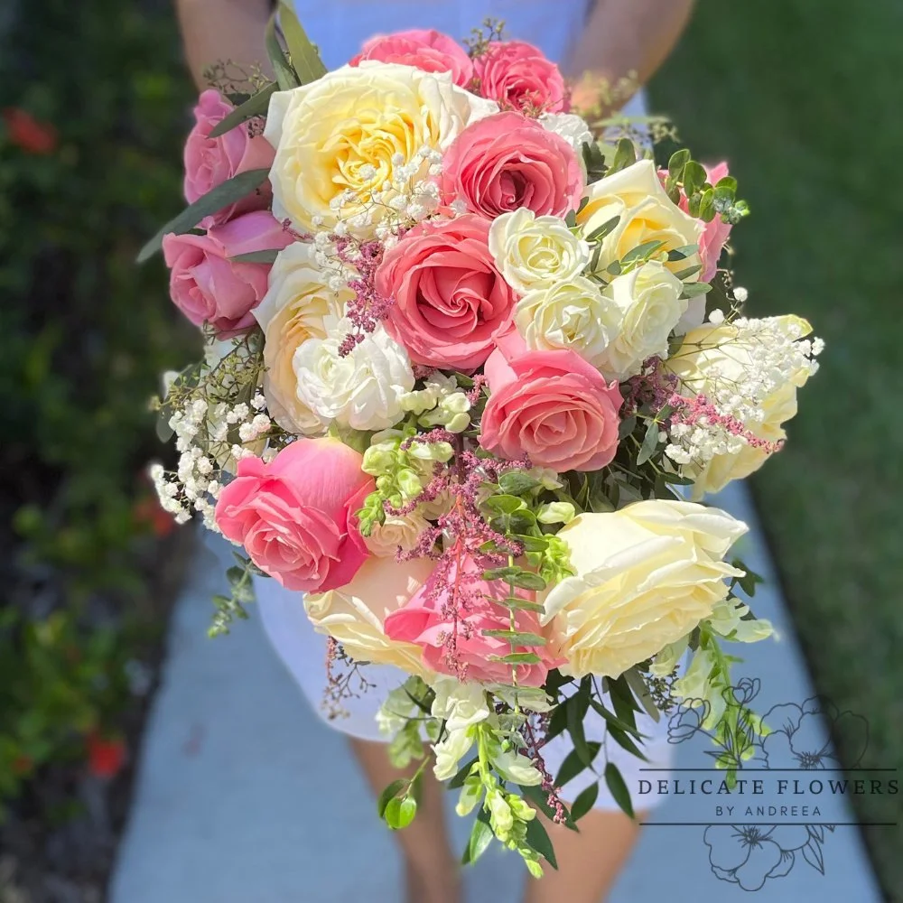 Romantic Rose Cascade bridal bouquet with pink and ivory roses, baby’s breath, and cascading greenery