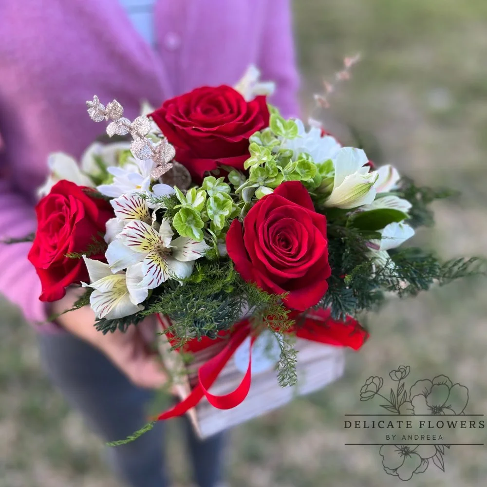 Festive Bloom Christmas flower arrangement with red roses, white alstroemeria, and green foliage