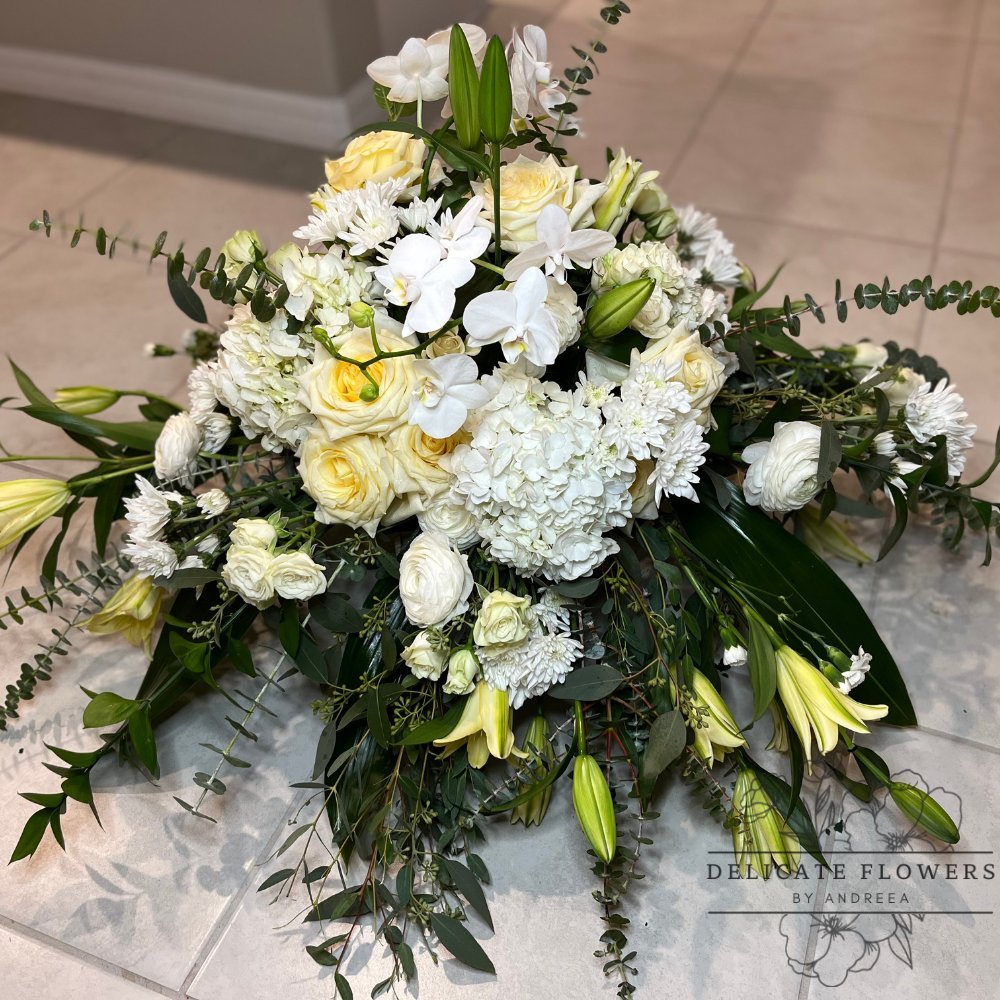 Eternal Elegance funeral sympathy flower arrangement with ivory roses, white hydrangea, orchids, chrysanthemums, and cascading greenery