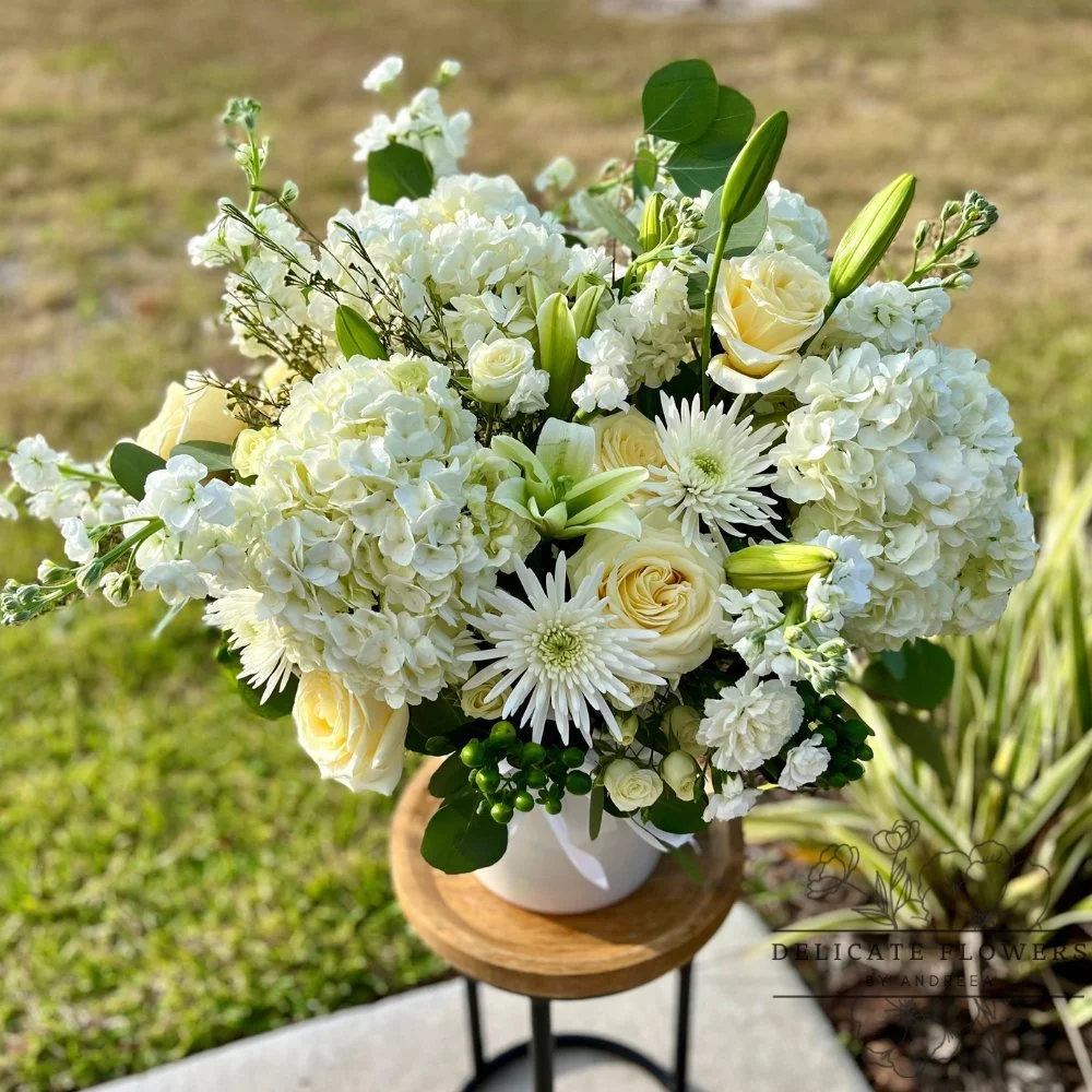 White hydrangea, rose, lily, and mum arrangement in a white vase by Delicate Flowers by Andreea in Wesley Chapel FL
