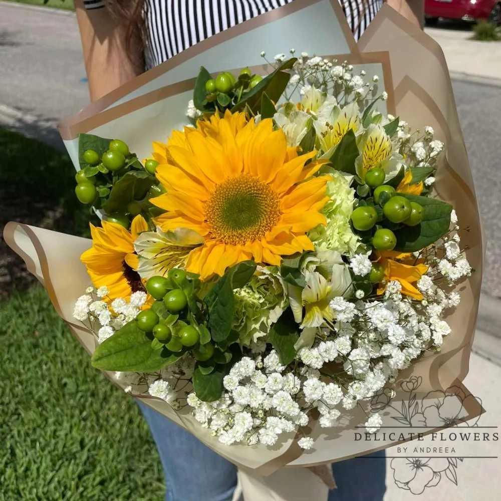 Warm Sunshine flower arrangement with bright, golden-toned blooms and fresh greenery