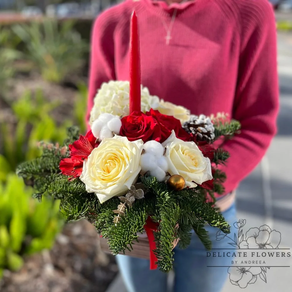 Holiday Harmony Christmas flower arrangement with red roses, white blooms, and lush greenery