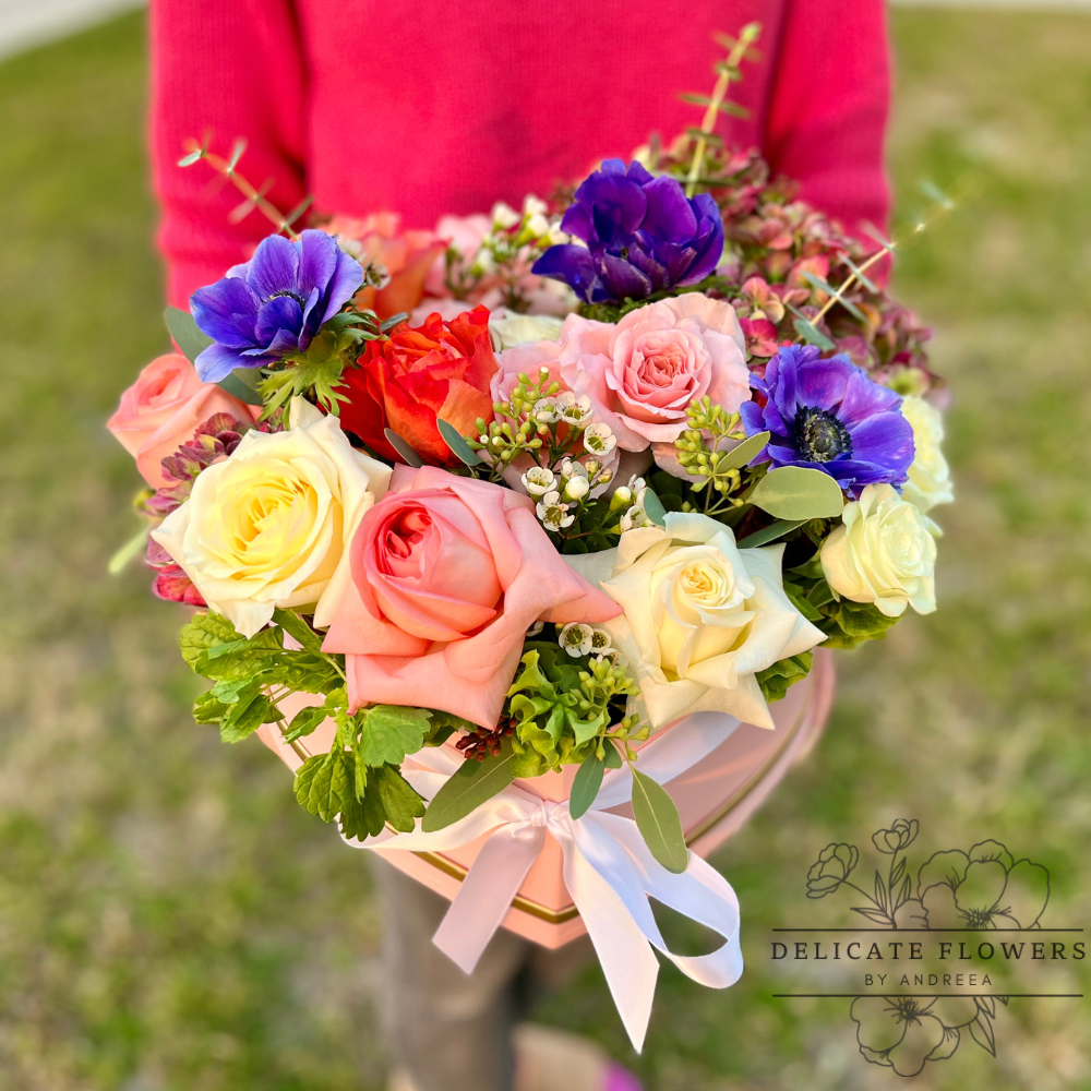Sunset Anemone heart-shaped flower arrangement with peach and cream roses and blue and purple anemones