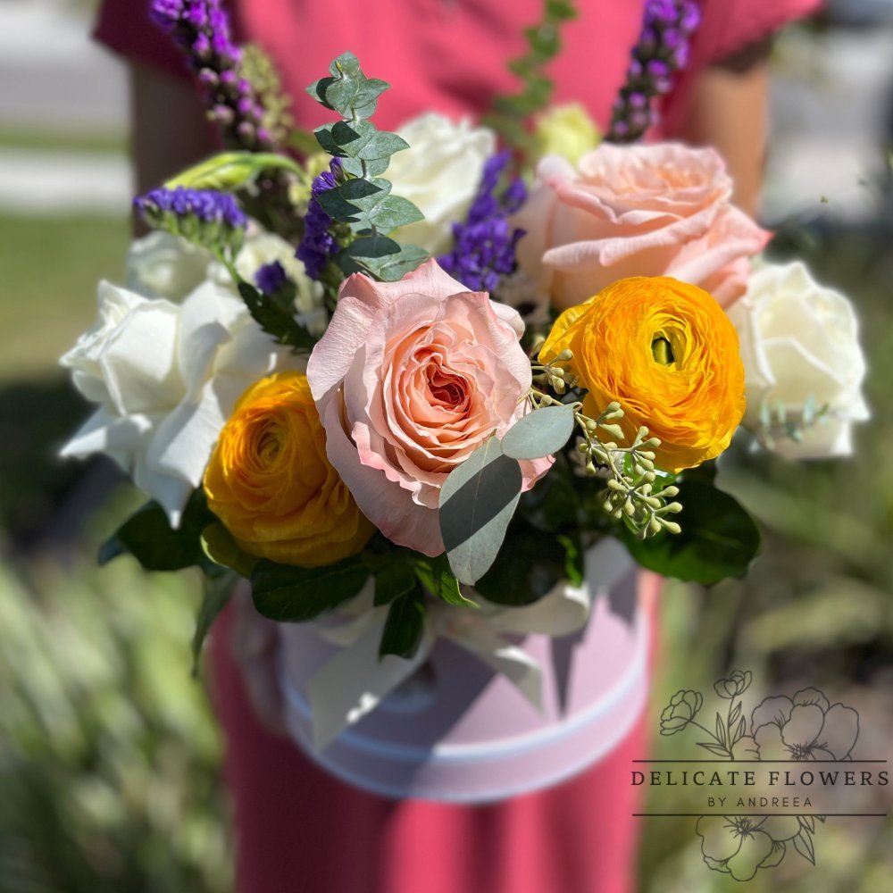 Graceful Gems flower arrangement with blush roses, golden ranunculus, white blooms, lavender accents, and eucalyptus