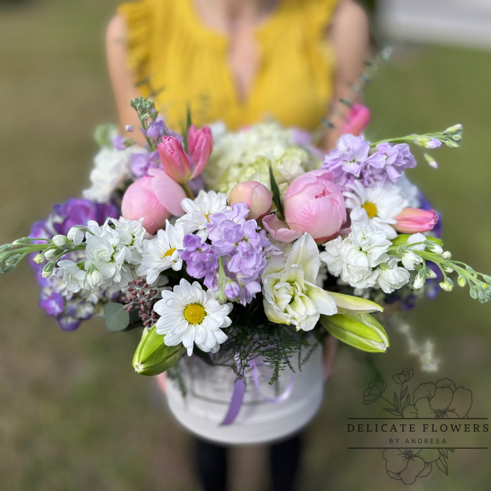 Blushing Spring features blush peonies, tulips, daisies, and lilac stock balanced with creamy hydrangea and lilies. Handcrafted flower delivery in Wesley Chapel, FL