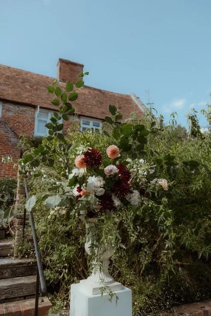 Updown-farmhouse-wedding-flowers-plinth-urn.webp