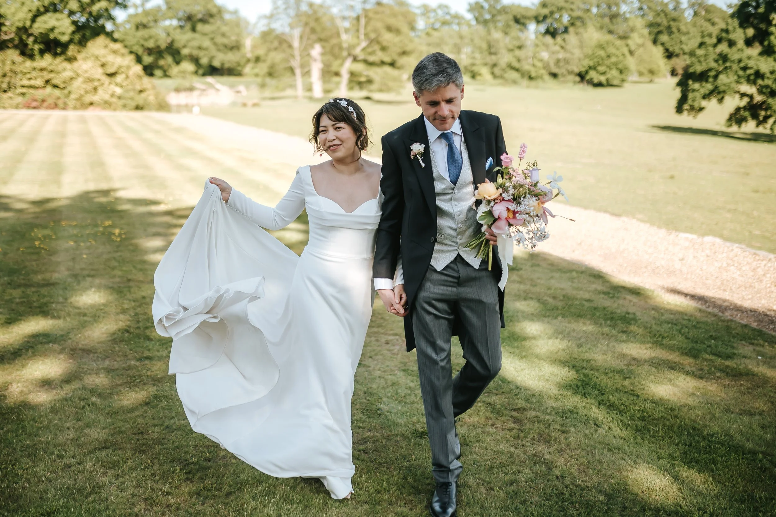 wadhurst-wedding-couple-walking-lawn-wadhurst-castle.jpg