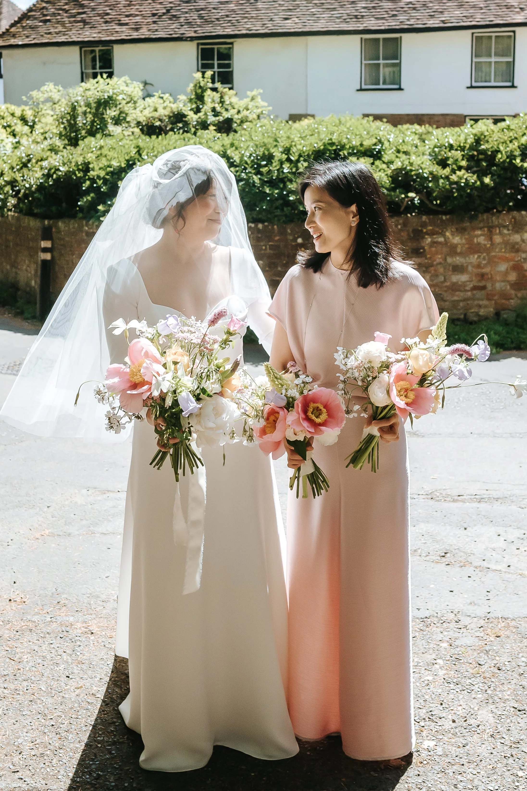 wadhurst-wedding-bride-bridesmaid-veil-before-church-ceremony.jpg