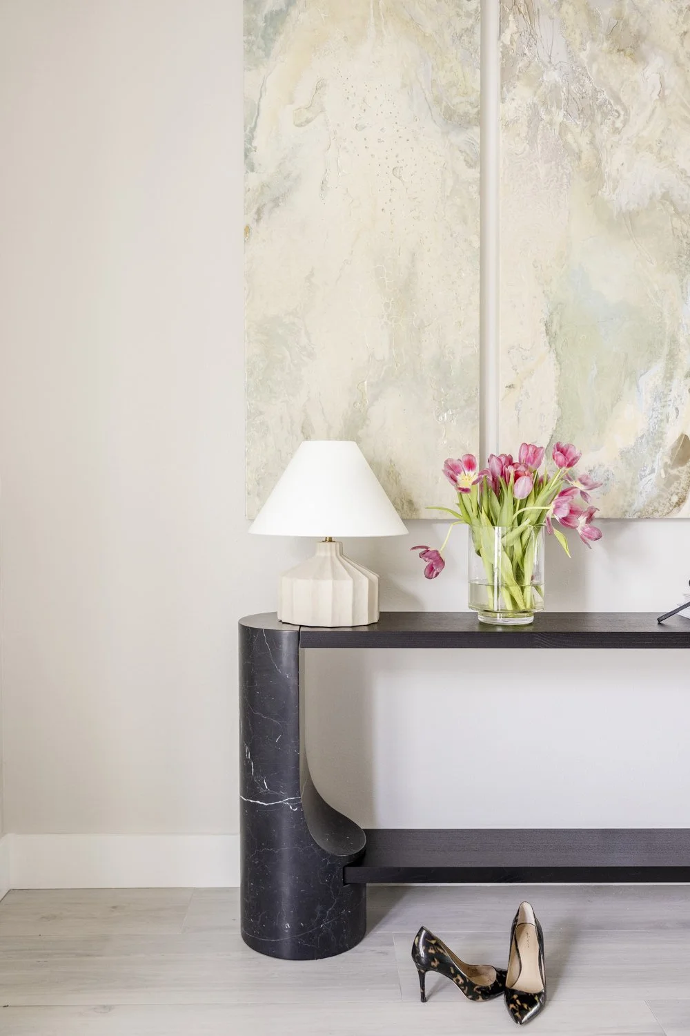 Entryway with black marble console and sculptural table lamp