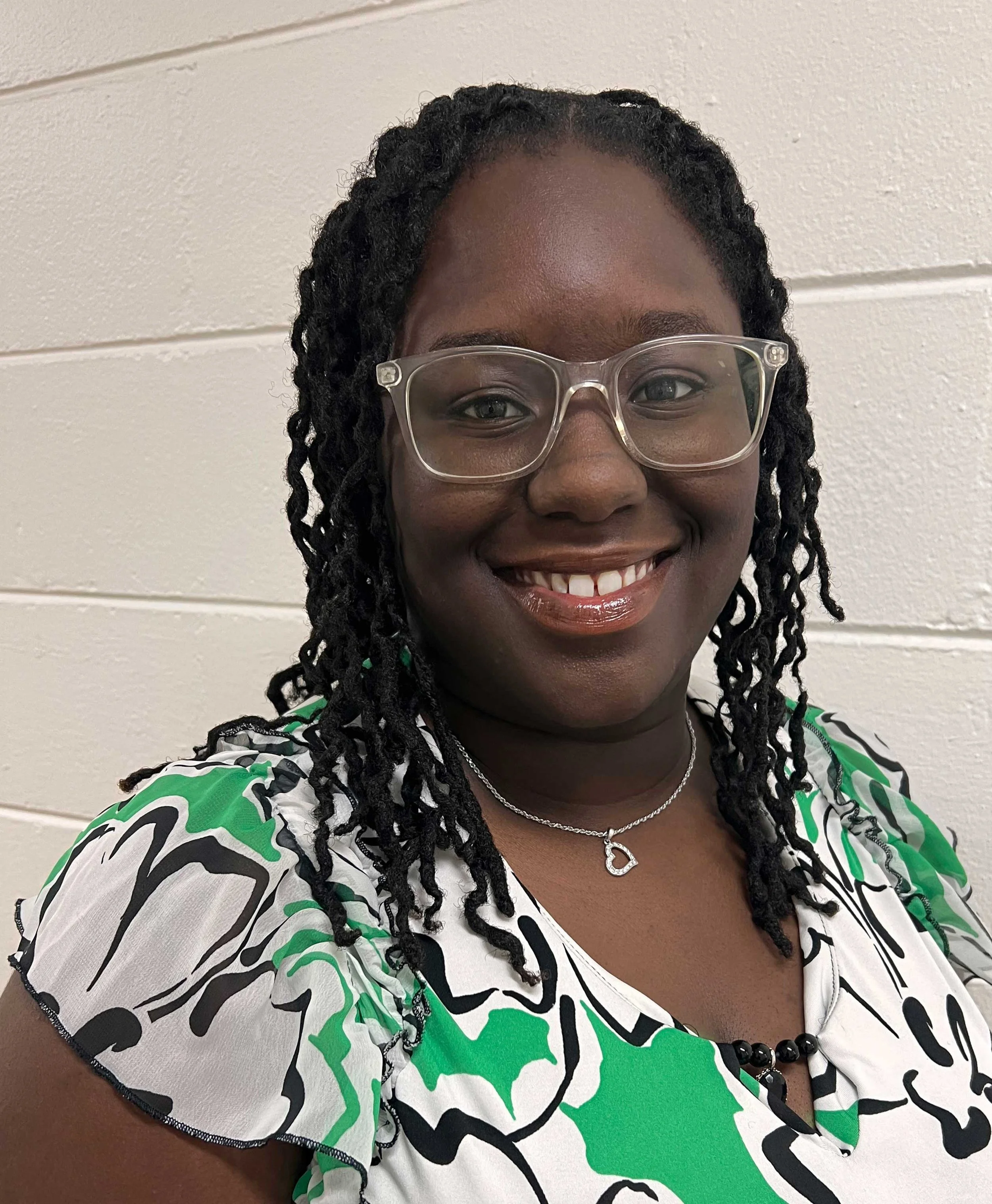 headshot of a female in royal blue polo shirt