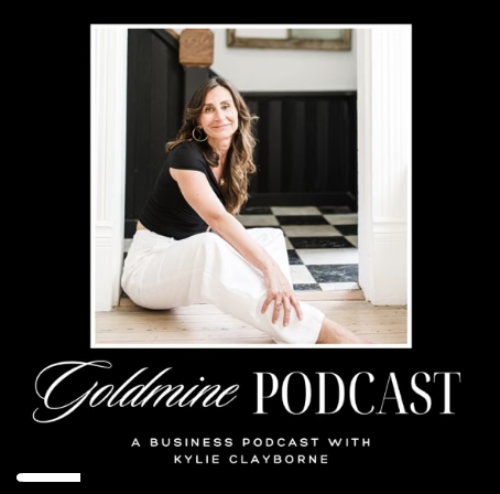 A woman sitting on the floor in a doorway, smiling, with a black and white checkered floor in the background, and text overlay reading "Goldnine Podcast" and "A Business Podcast with Kylie Clayborne."