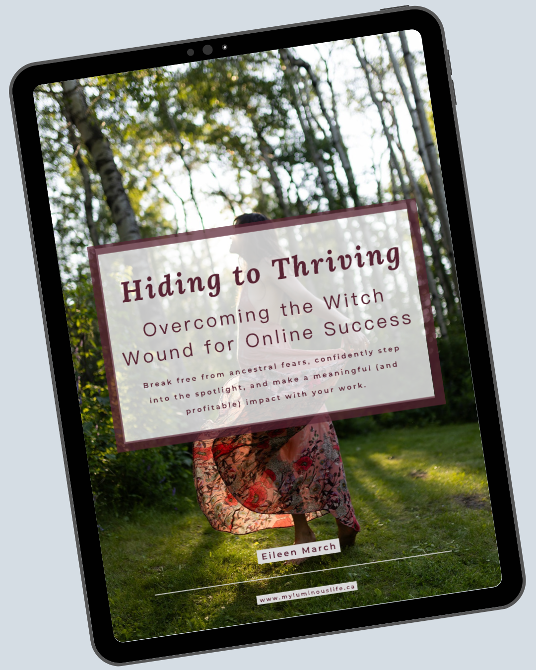 tablet with image of woman in pink dress in woods and text overlay