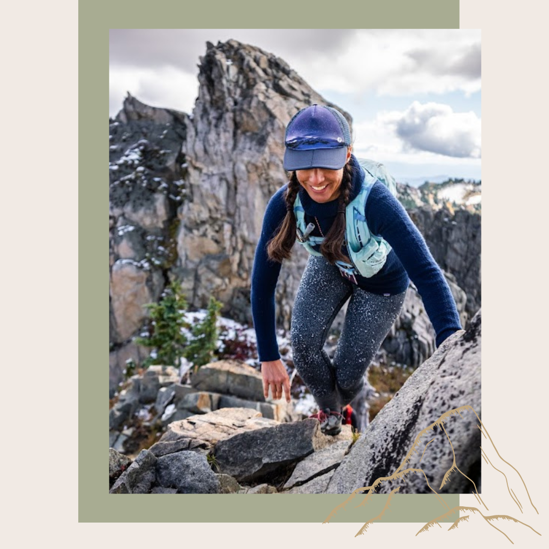 Erin is trail running a mountain in Washington smiling