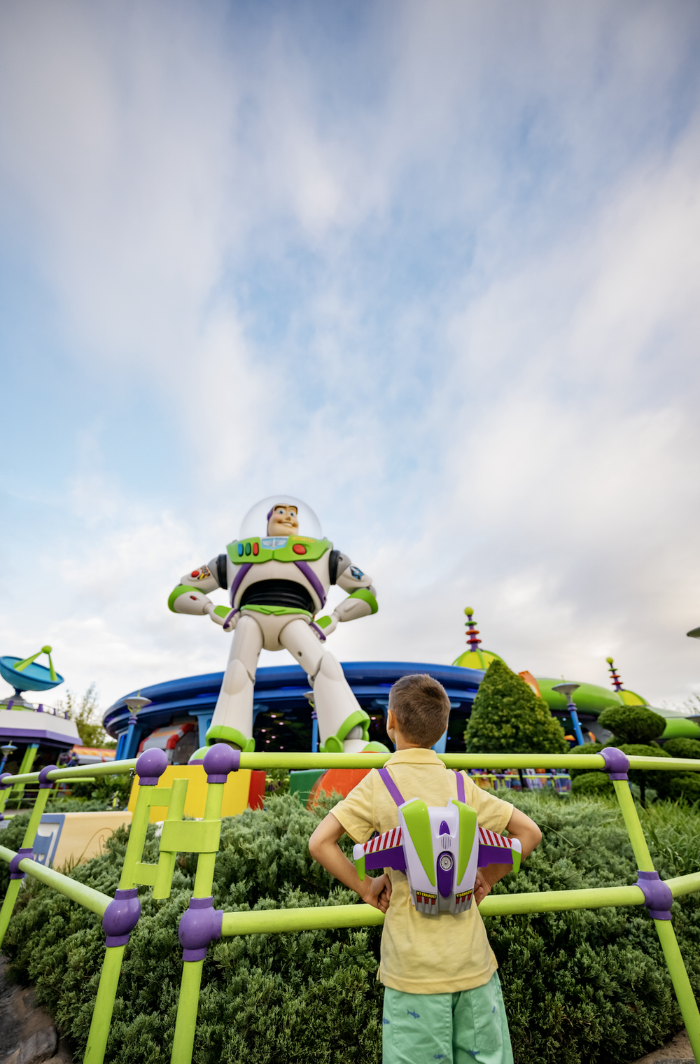 Boy looking at Buzz Lightyear at Disney