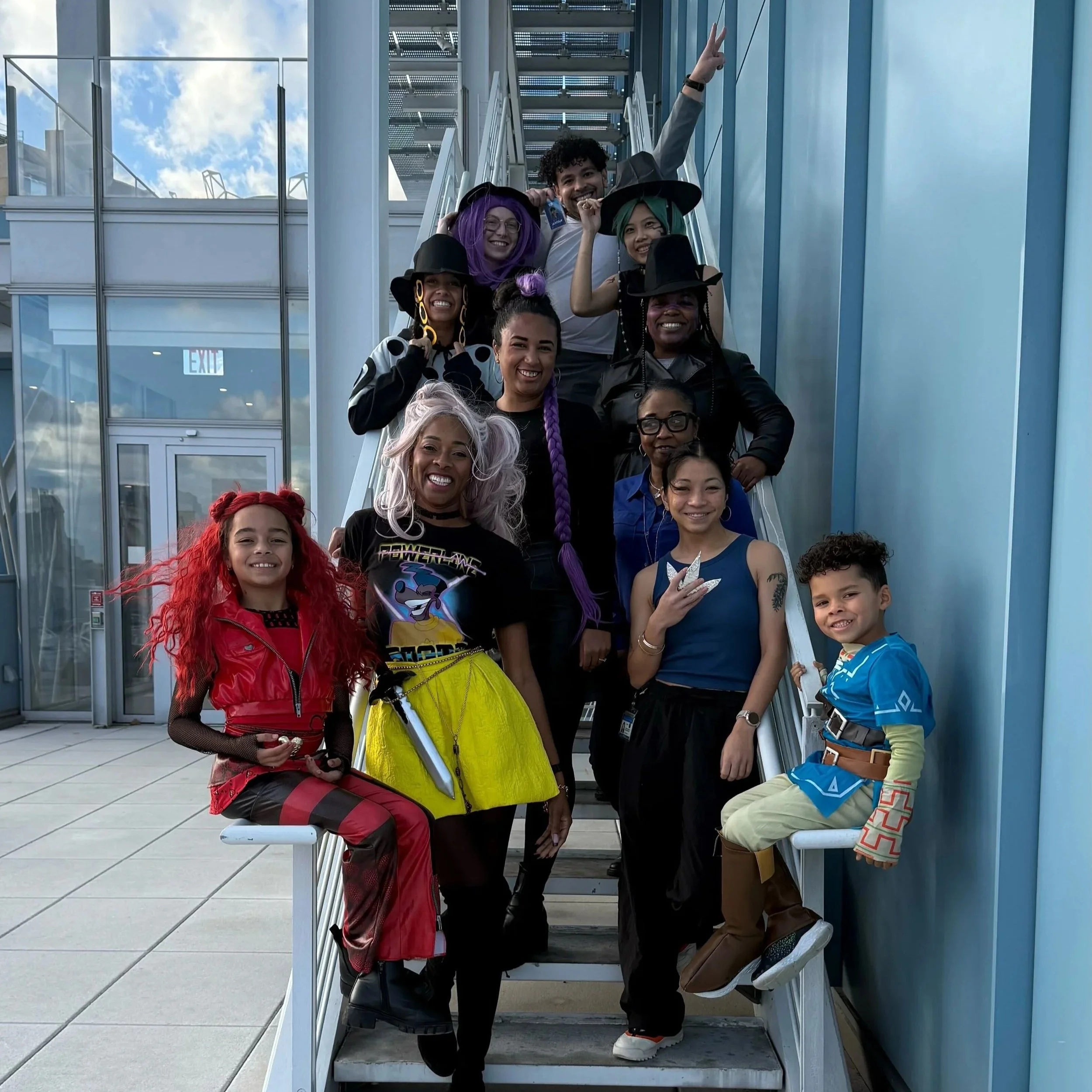 The Marlin Lab in movie and cartoon costumes posing on a staircase. 
