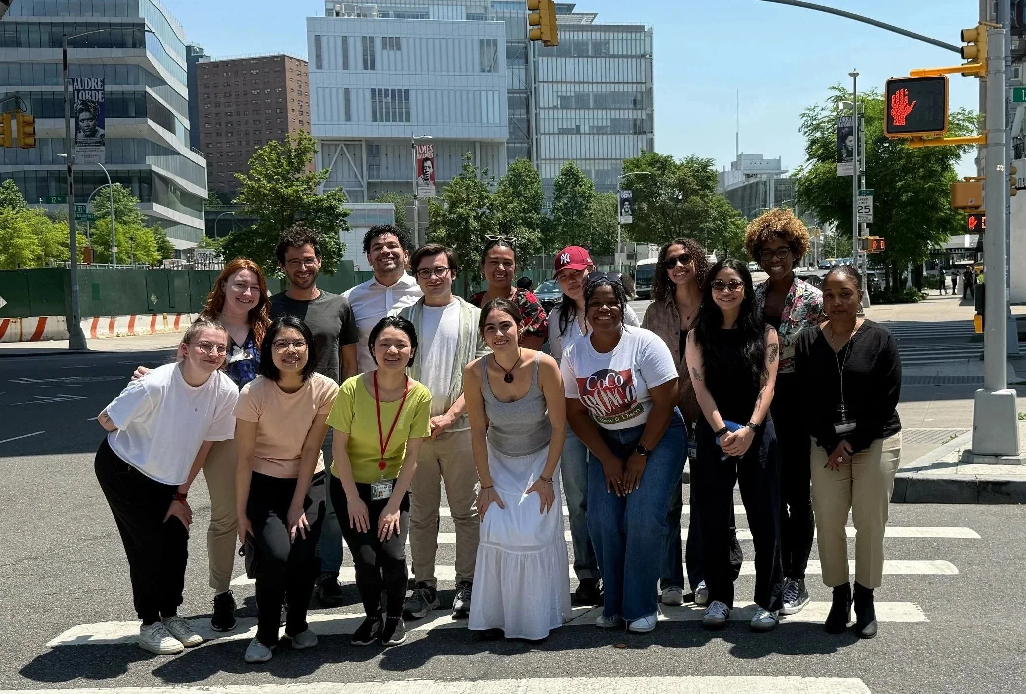 Marlin Lab members standing and smiling on a city crosswalk during daytime.