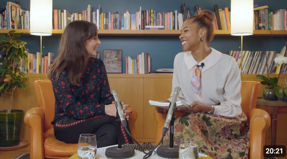 Dr. Gisella Vetere and Dr. Bianca Jones Marlin are seated in a library, having a discussion. Both scientists are smiling and Bianca is holding a notebook.
