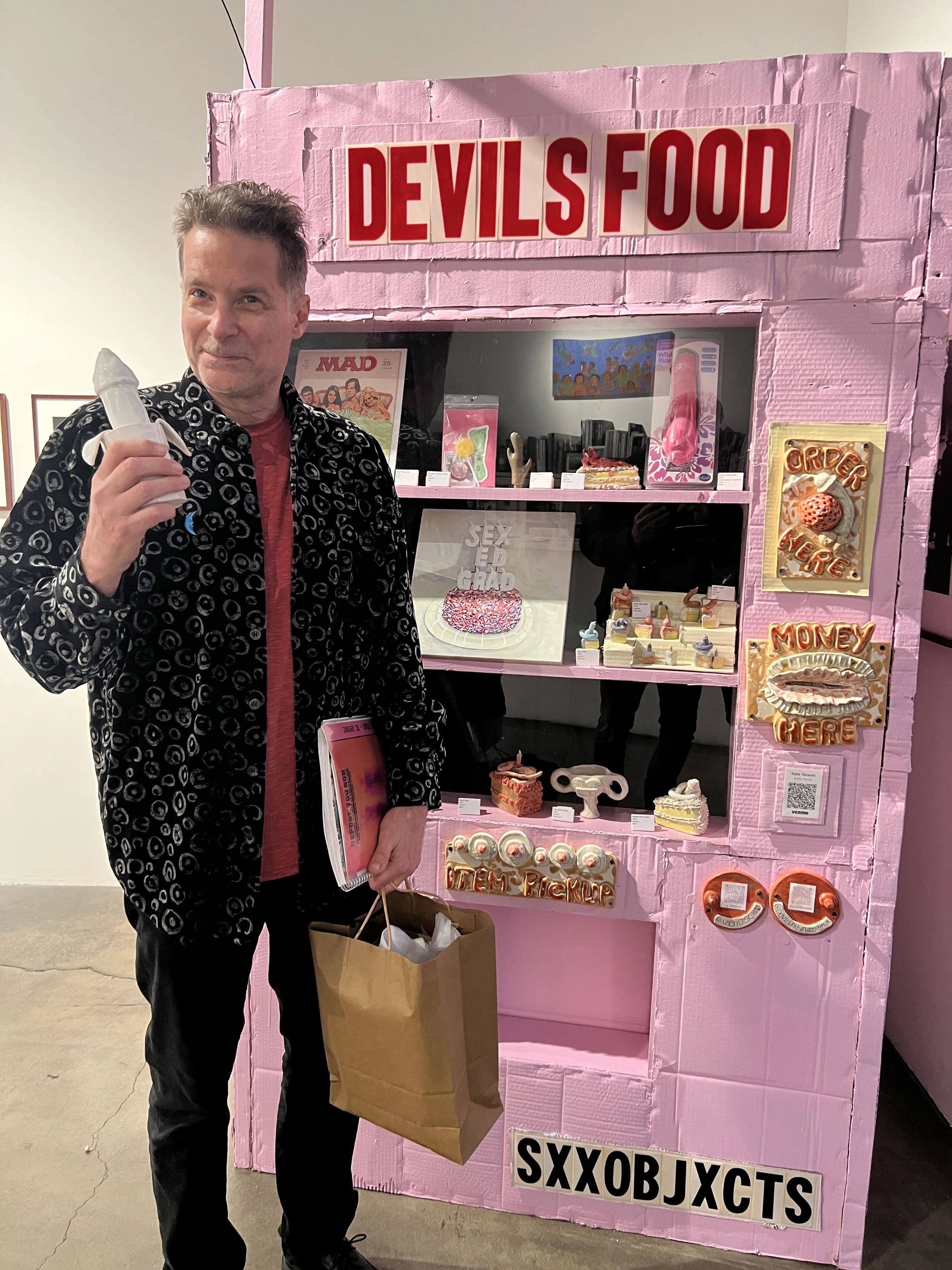 Osceola Refetoff with a sculpture he purchased from the Devil's Food Vending Machine pop-up, Bergamot open house, 2025 