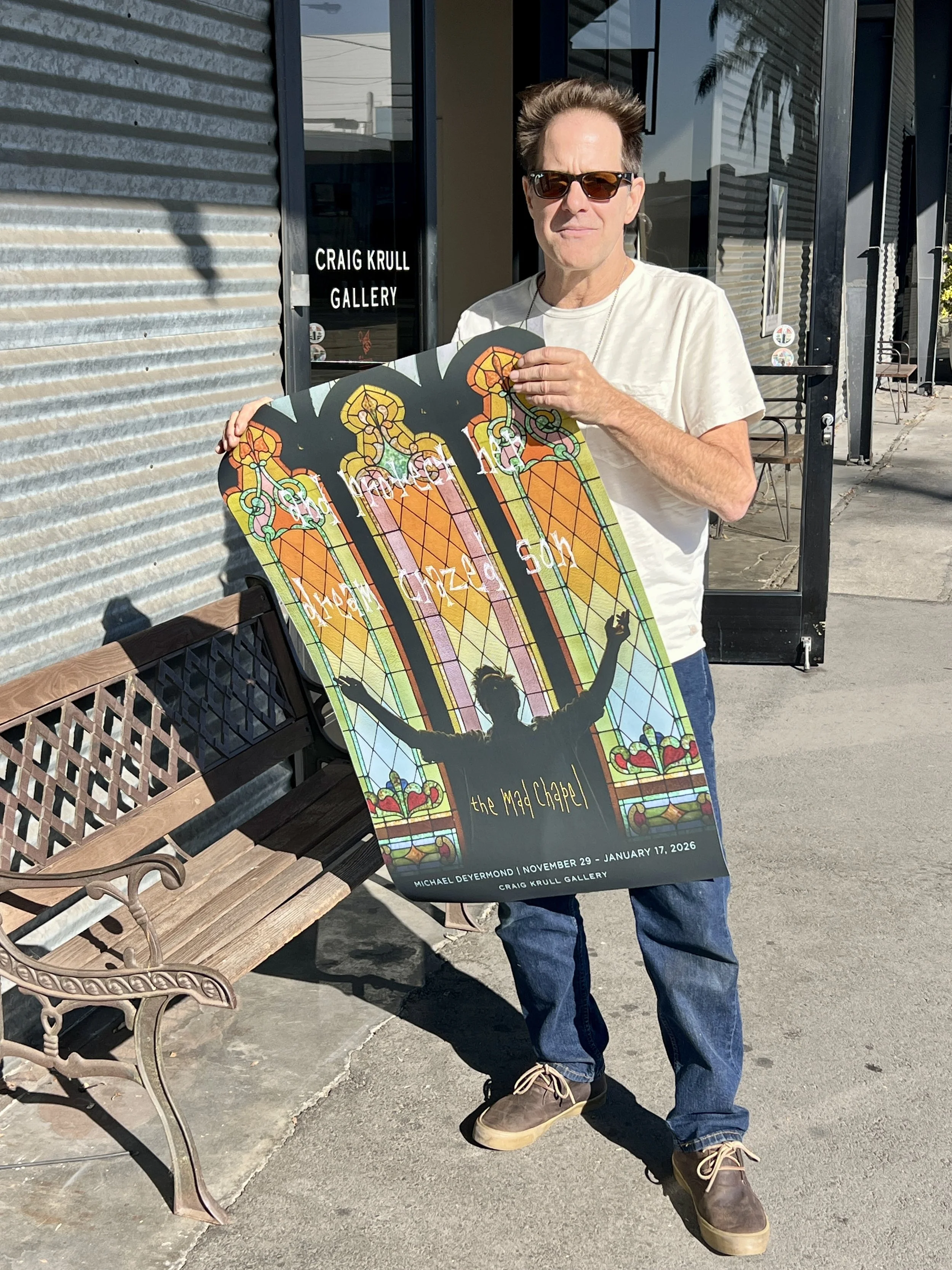 Michael Deyermond with his exhibition poster, 2025