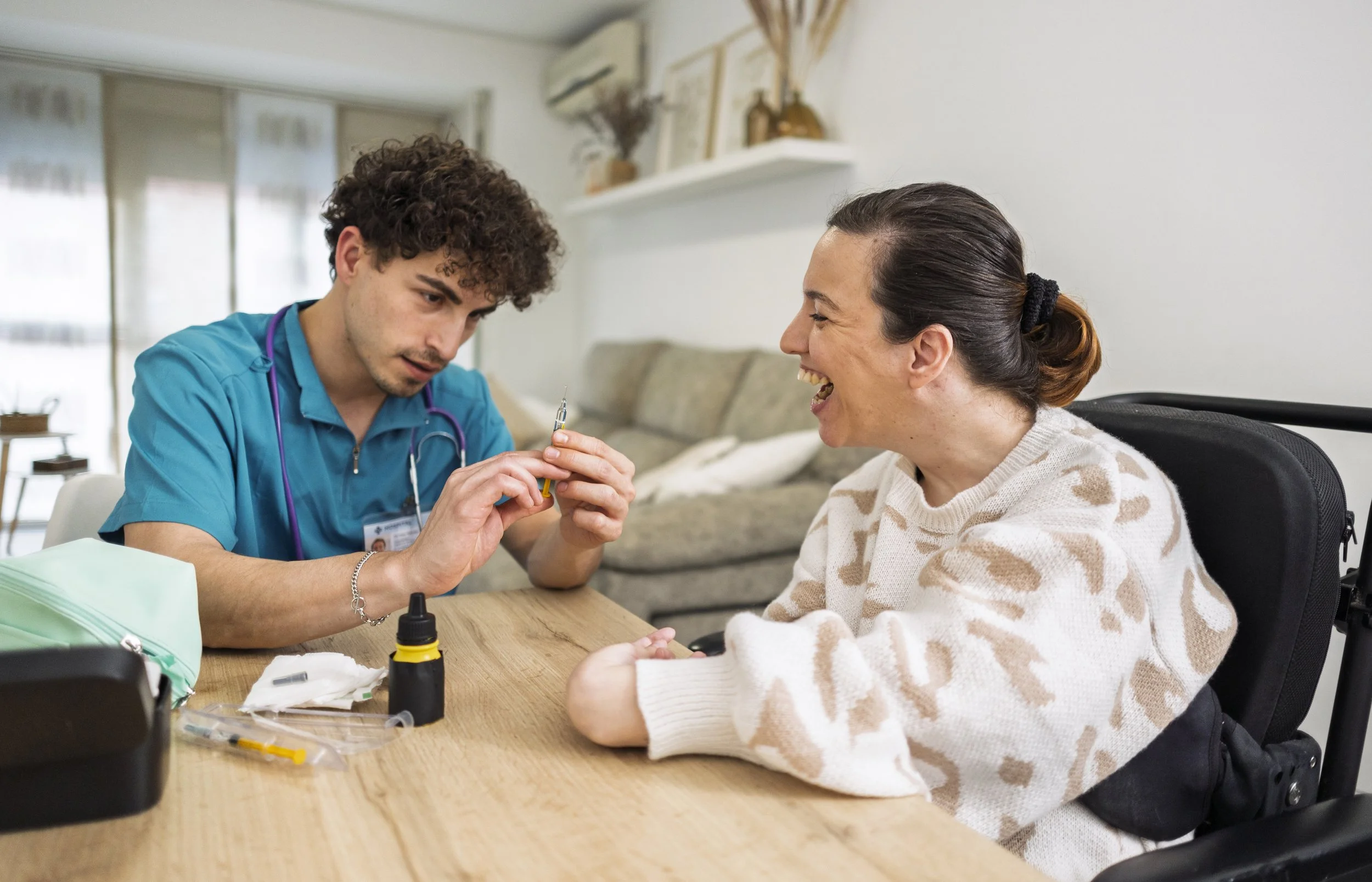A male nurse prepares a syringe for a home-bound patient