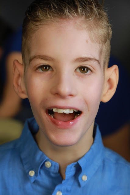 A portrait of Liam with a bright smile