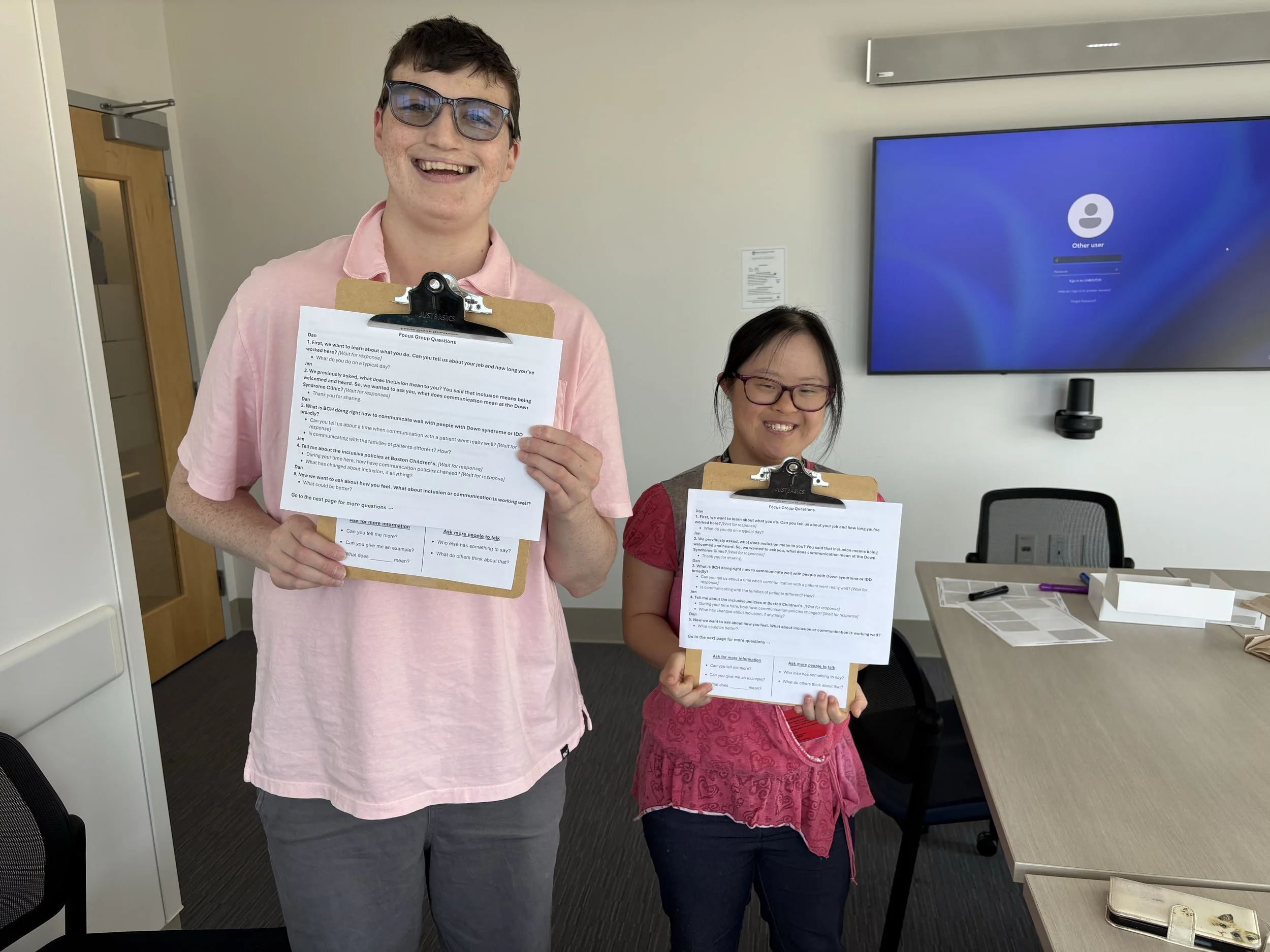 Researchers with IDD hold clipboards with the data they are collecting.