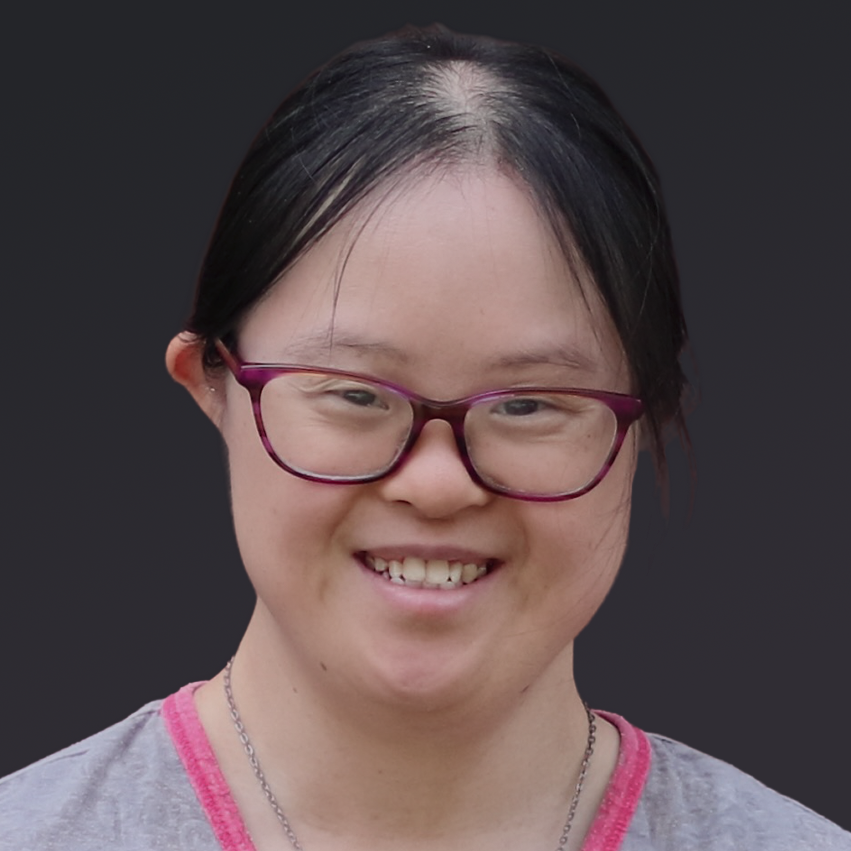 Jennifer is an Asian American with Down syndrome, glasses and a happy smile.