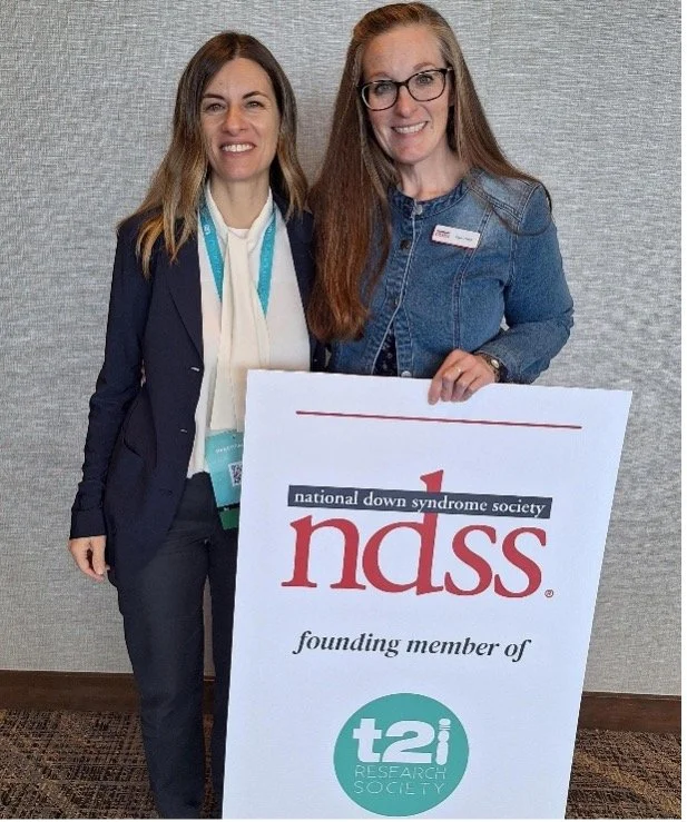 2 women holding a poster for NDSS