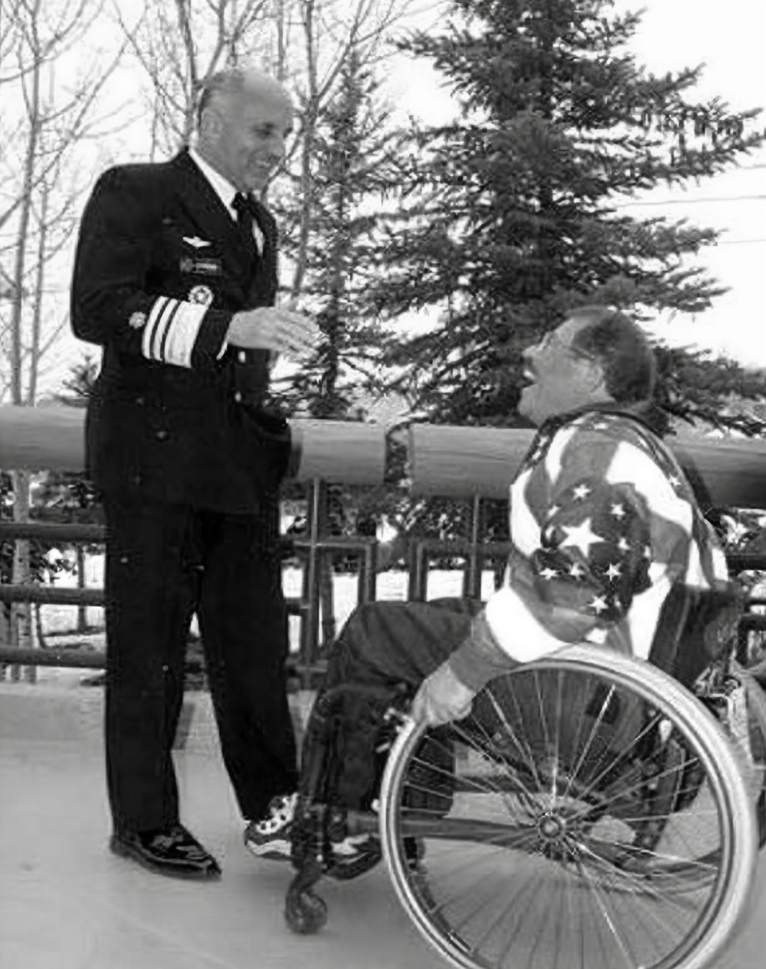 Dr. Richard Carmona talks with a man who is in a wheelchair