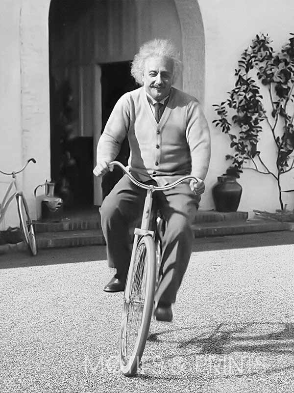 A vintage photo of Einstein riding a bicycle