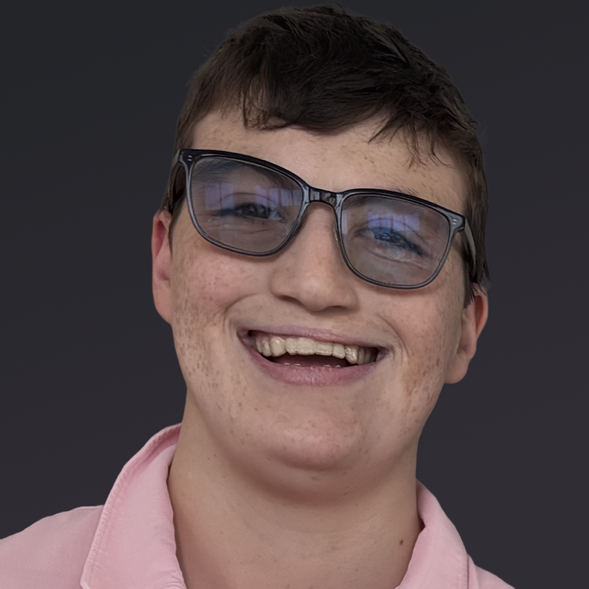 Daniel has a bright smile, glasses and IDD.