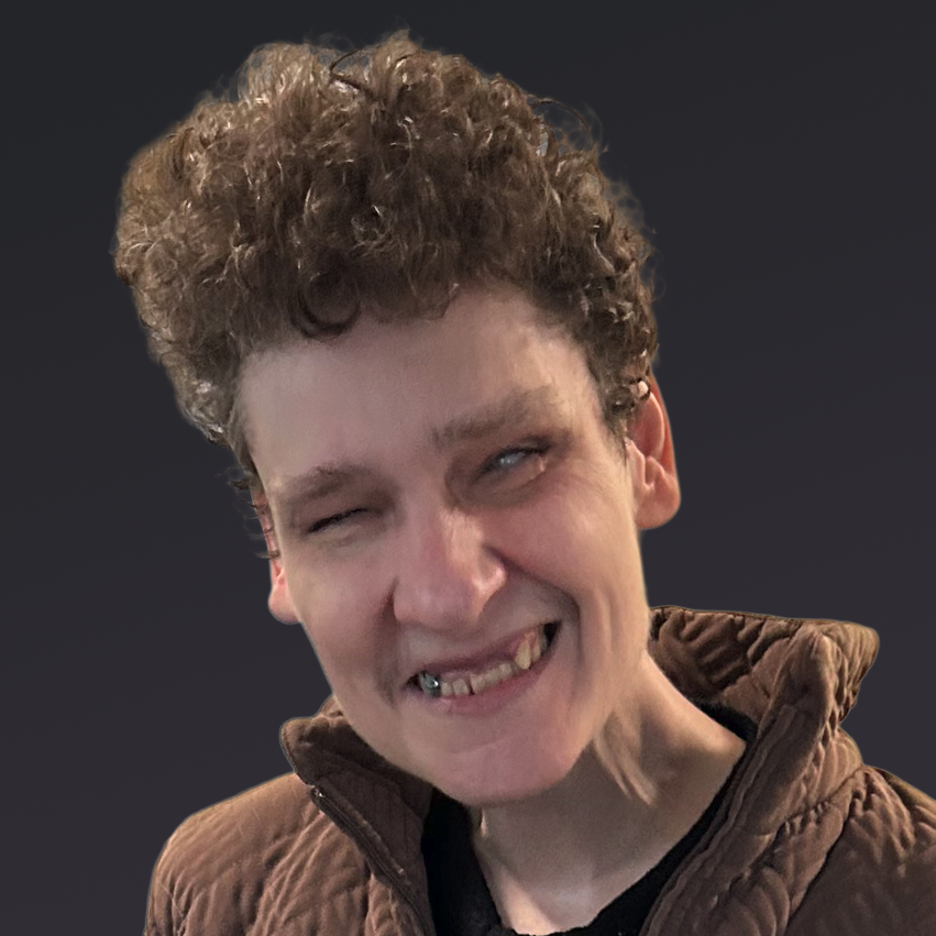 Portrait of Denise, a happy woman with short, curly hair