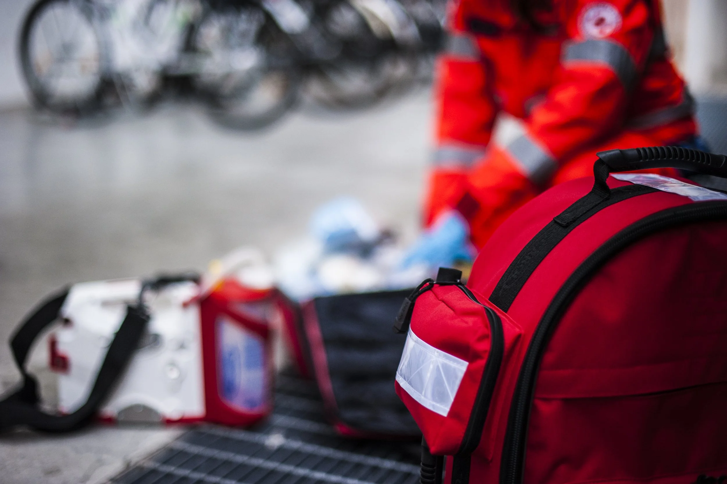 A paramedic reaches into their medical bag.