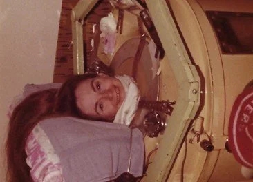A younger Lillian smiles while in her iron lung
