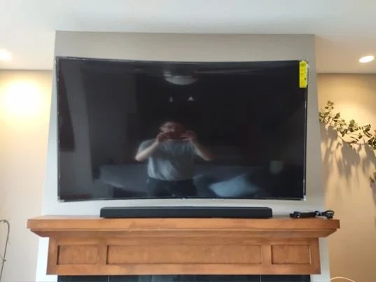 curved angled screen over fireplace